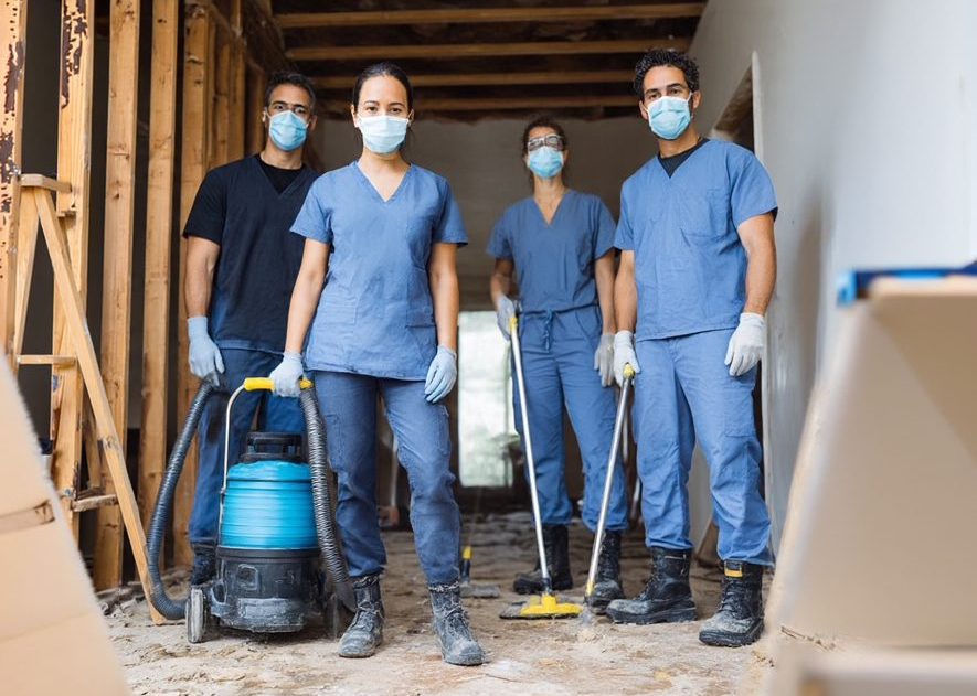 HOUZPITAL clean up crew in scrubs and masks